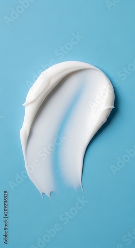 Smooth White Cream Smear Resting on Bright Blue Background