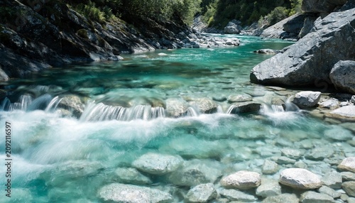 Turquoise alpine river rushing over smooth white stones in a rocky gorge, sunlight sparkling through crystal clear water, fresh mountain wilderness, summer travel escape, pristine nature scenery
