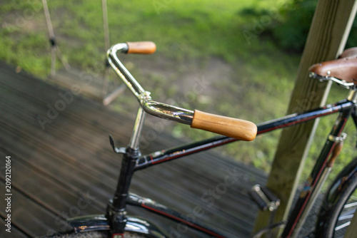 Bilde på lerret Close-up of polished chrome bicycle handlebars with wooden grips on a vintage bi