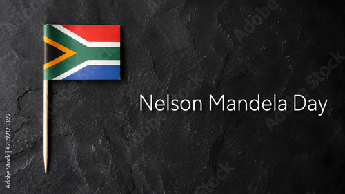 Nelson mandela day concept with south african flag on black slate background