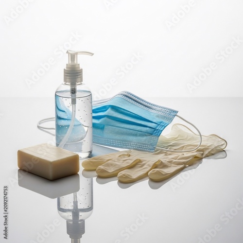Sanitary Essentials: Hand sanitizer, mask, gloves, and soap on a reflective surface, soft lighting.
