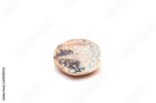 Obraz na plátně Rotten moldy slice of sausage isolated on white background.