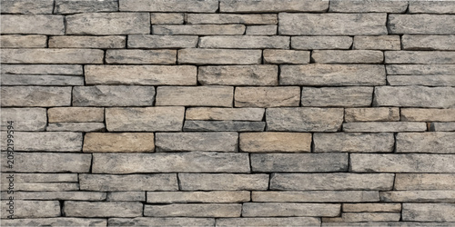 Light beige gray stone brick wall surface texture background with staggered pattern design for construction architecture decorative projects