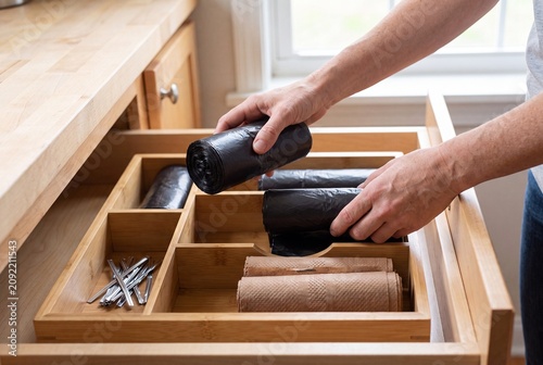Organized Kitchen Drawer with Trash Bags Paper Towels and Household Cleaning Supplies