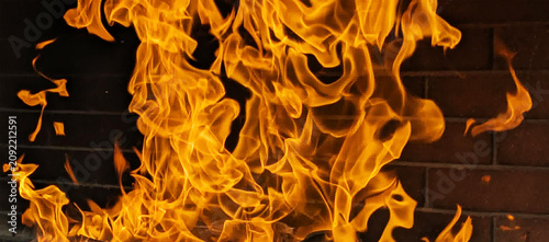 Fire in the fireplace. Burning Fire in Fireplace – Cozy Home Hearth with Glowing Flames.  Winter Comfort Concept Photo. Original Photo. 