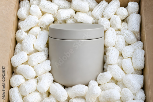 Close-up of consumer goods nestled in water-soluble organic cornstarch protective packaging peanuts.