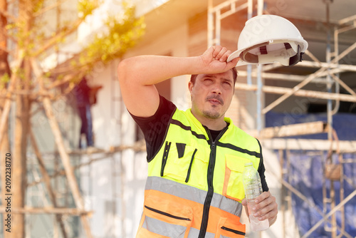 Outdoors worker impact from Heatwave in Europe, Engineer male construction builder sweating