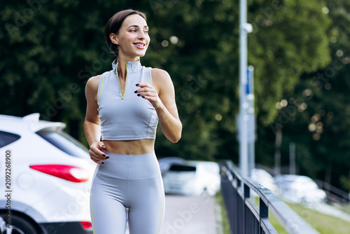 Fotografie Active woman making a jog on a path, staying fit and healthy