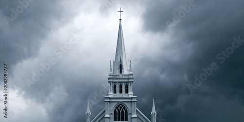 Tapety artystyczne Gothic-style Church Spire Rising Against Stormy Sky