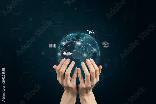 Human hands holding glowing digital globe for global logistics and international shipping supply chain network