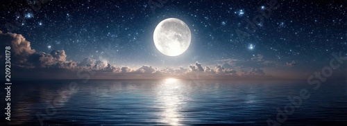 Full Moon Shines Brightly Over Calm Ocean Water Under Starry Night Sky With Wispy Clouds Reflected on Surface