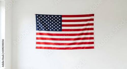 American flag hangs proudly on a clean white wall indoors