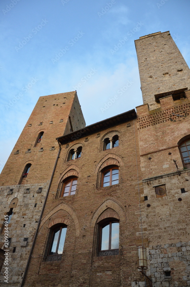 Fototapeta premium San Gimignano, Italy 03.04.2020: Town Hall (also known as the Palazzo del Popolo or Palazzo Nuovo del Podestà) and the Torre Grossa in San Gimignano