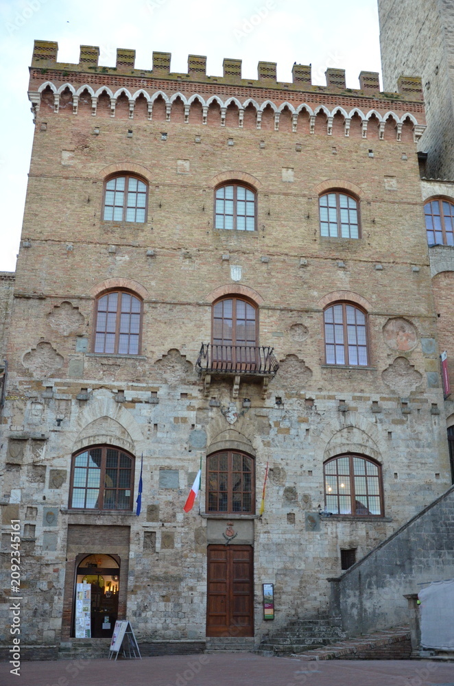 Fototapeta premium San Gimignano, Italy 03.04.2020: Town Hall (also known as the Palazzo del Popolo or Palazzo Nuovo del Podestà) and the Torre Grossa in San Gimignano