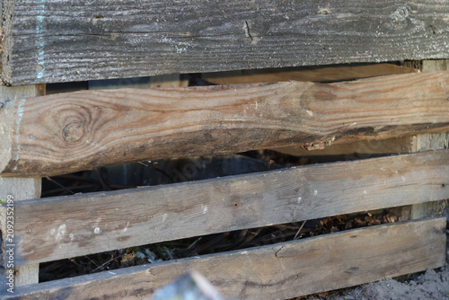 Fragment of a wooden fence. Old unpainted boards nailed horizontally.