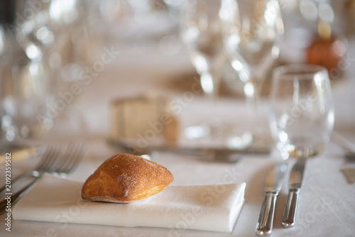 Fresh bread roll on elegant restaurant table setting with copy space