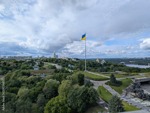 Kyiv cityscape with large Ukrainian flag