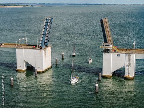 Fotografie Zeeland Bridge open for sailboats navigating Oosterschelde waters, passing raise