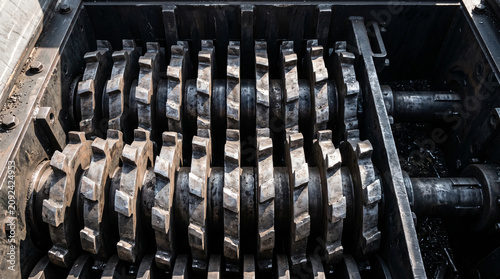 Close-up of heavy-duty industrial shredder blades for waste recycling.