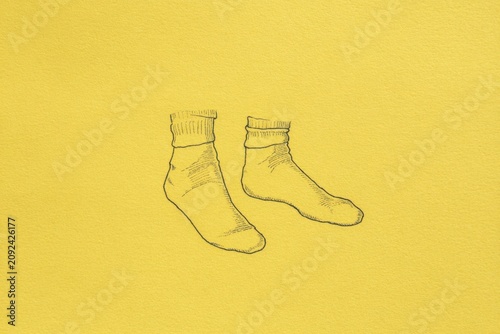 closeup of feet in socks, drawing on a yellow background
