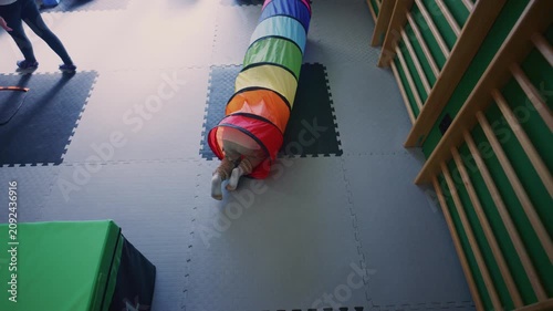 A young boy actively participates in kids fitness activities, navigating a vibrant soft play environment.