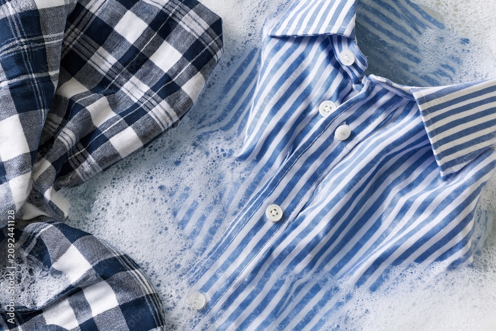 Obraz premium The Blue Striped Shirt Drenched in a Sea of Foamy Bubbles