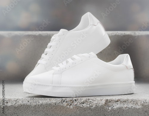 Displaying White Sneakers on Concrete Outside with Neutral Viewpoint and Simple Composition
