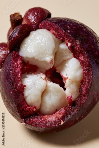Mangosteen Halved Purple Rind Crown Calyx White Segmented Flesh Teal Background Vertical Macro
