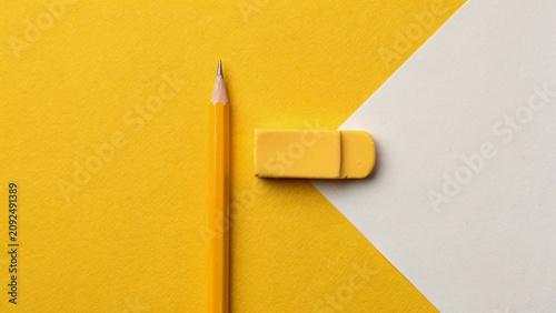 Educational workspace with pencil and eraser on geometric background.