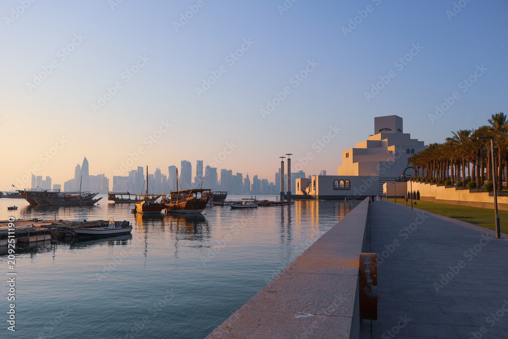 Fototapeta premium Museum of Islamic Art with Doha Skyline and Traditional Dhow Boats, Qatar