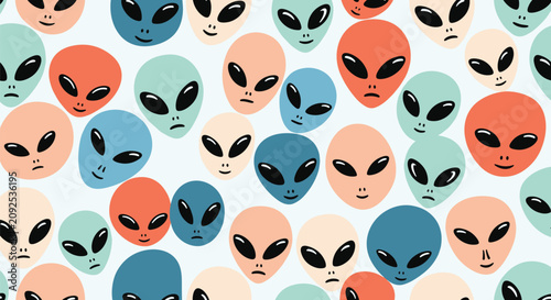 Colorful cartoon alien heads seamless pattern on light background for modern nursery wallpaper and fabric.