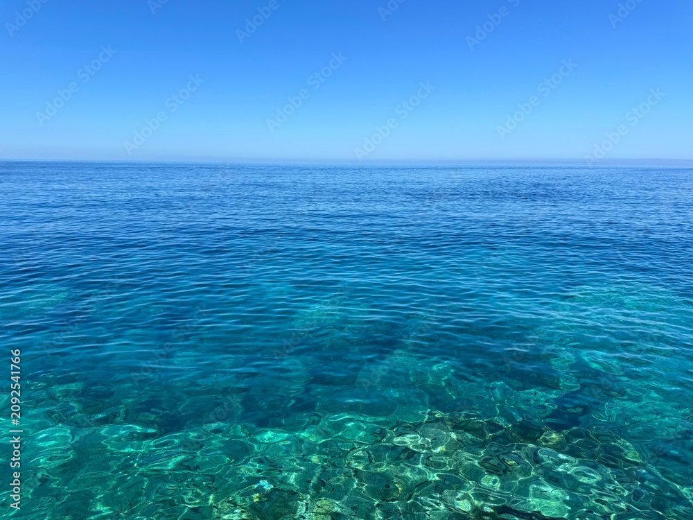 Fototapeta premium Turquoise blue sea and sunny clear sky.
