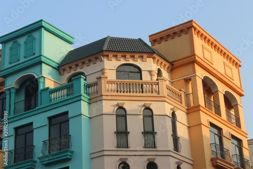 Exterior view of mediterranean buildings with pastel colors and classic balconies.