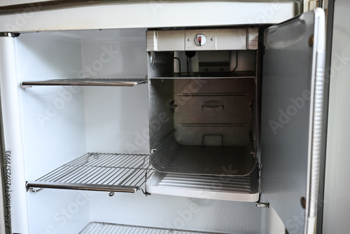 Quadro su tela Interior view of an empty vintage refrigerator with wire metal shelves and built