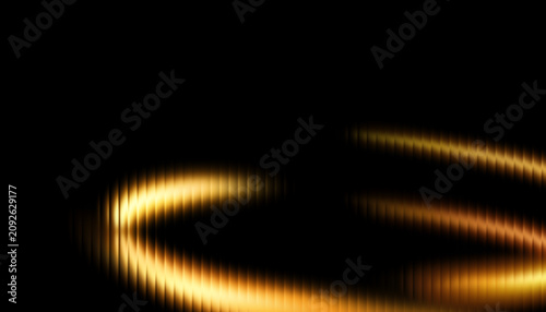 Bright golden light streaks form a curved circular motion path against a dark black background creating an abstract visual effect.