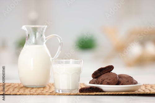 Photography Fresh milk and tasty chocolate cookies on light table indoors