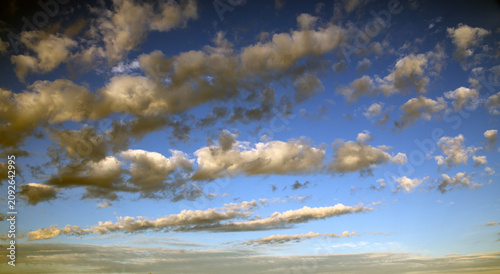 Fotografie A clear blue sky with scattered white clouds