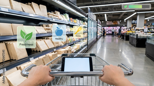 Shopping cart with tablet, grocery store aisle, eco friendly products, sustainable shopping