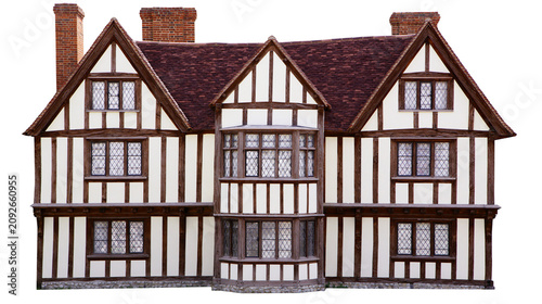 Fotografie Tudor style timber-framed house with multiple windows and brick chimneys, isolat