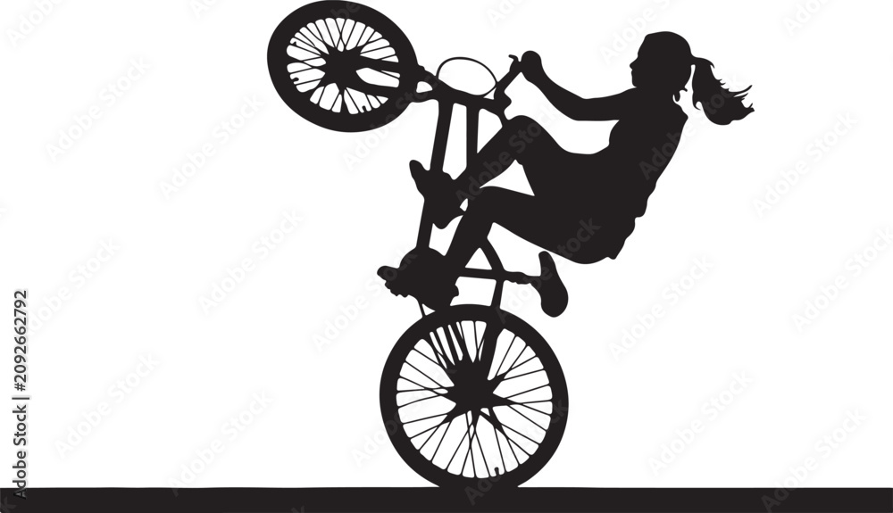 Obraz premium Silhouette of a girl doing a wheelie on a bicycle