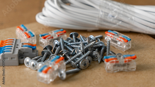 Fastening and electrical installation accessories. Automatic clamps for electrical wires, self-tapping screws, screws, cable