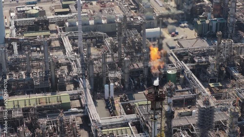 Industrial Plant Flare Stack Burning Gas in Daytime Aerial View