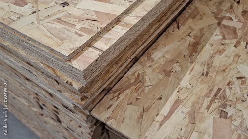 construction material texture. Layered OSB sheets at a carpentry workshop, construction supplies, chipboard hardware store inventory, natural brown wooden background, industry.