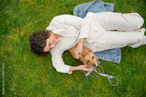Woman relaxing with her adopted dog in the park