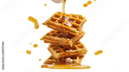 Stack of golden waffles with dripping syrup, isolated on transparent background