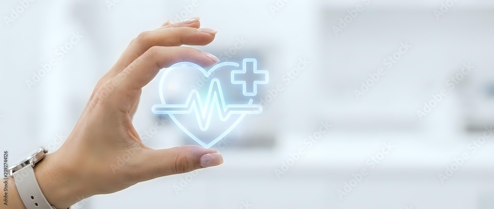 Obraz premium Caucasian hand holding glowing heartbeat and medical cross symbol, representing healthcare, wellness, and digital medicine services for hospital and clinic applications.