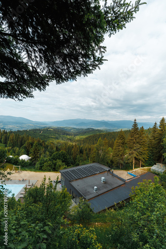 Luxury mountain resort with a swimming pool and scenic panoramic view.