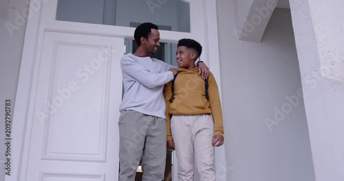 African American dad and son on porch, dad patting shoulder, teen leaving for school with backpack