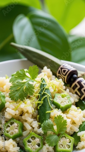 Gourmet okra in coconut rice with micro-cilantro and lime zest against fresh green negative space