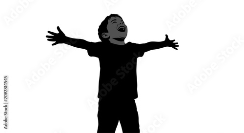 Silhouette of a young boy standing with arms outstretched in joy.